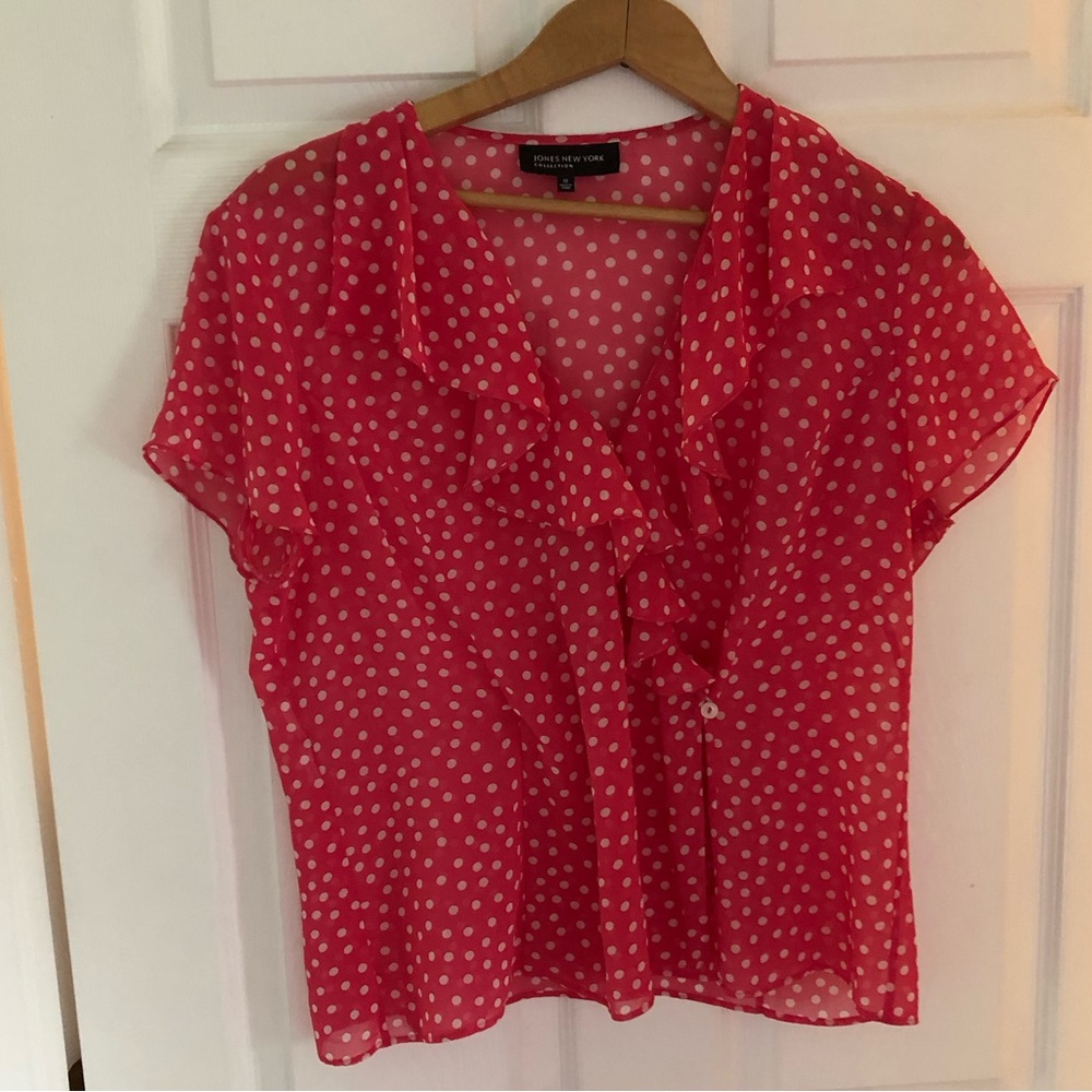 Polka dot blouse by Jones New York features a feminine ruffle-trimmed V-neck
